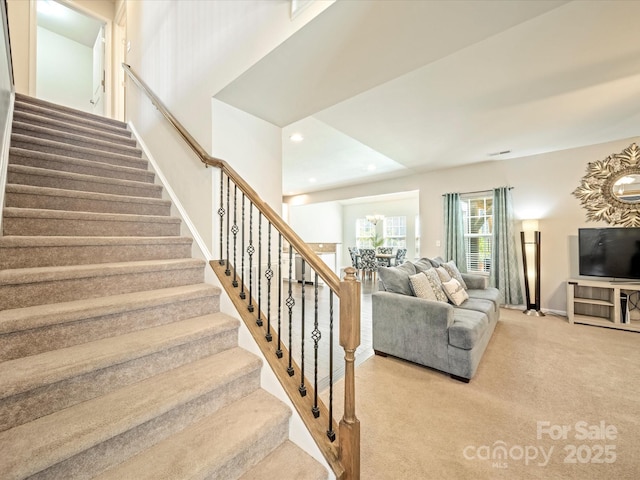 staircase featuring baseboards, carpet flooring, and recessed lighting