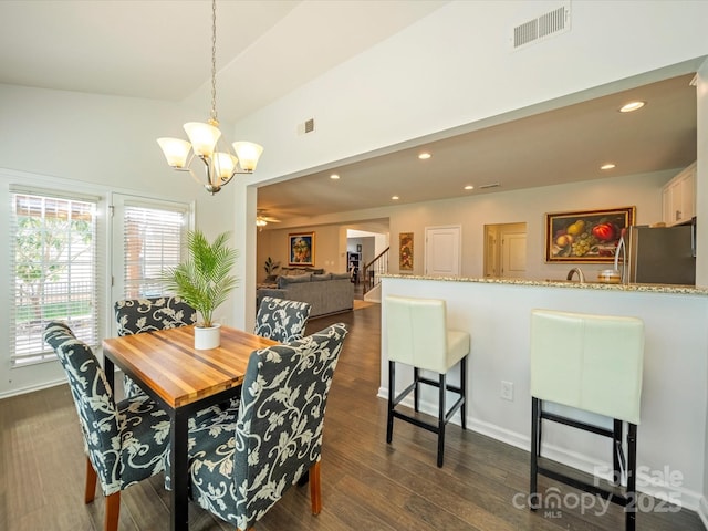 dining area featuring recessed lighting, visible vents, stairway, dark wood-style floors, and an inviting chandelier