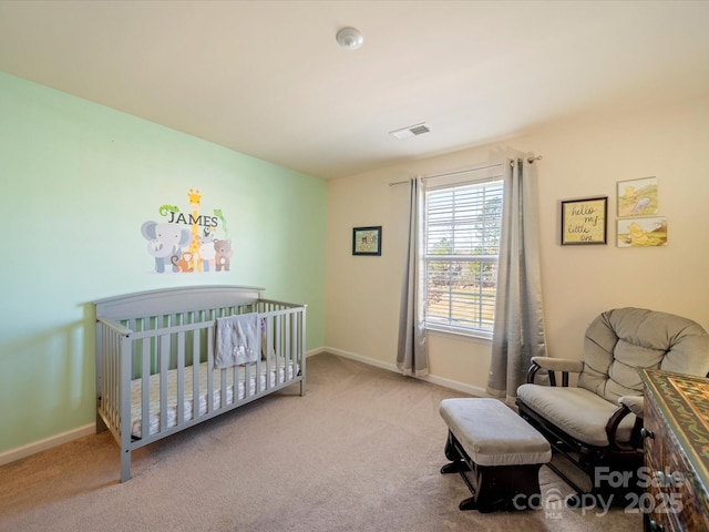 carpeted bedroom with a nursery area, visible vents, and baseboards