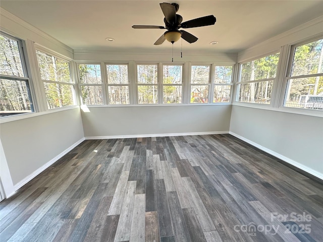 unfurnished sunroom with a ceiling fan