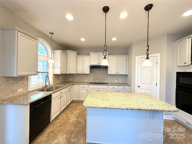 kitchen featuring under cabinet range hood, a sink, a kitchen island, black appliances, and tasteful backsplash