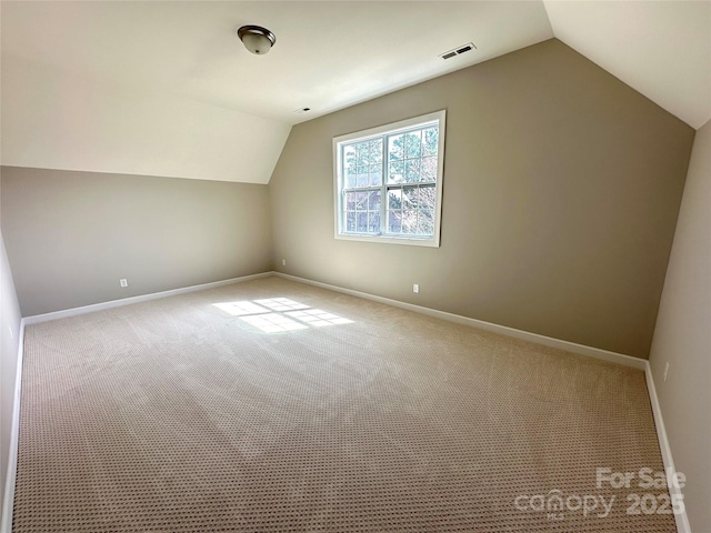 bonus room featuring vaulted ceiling, carpet, visible vents, and baseboards