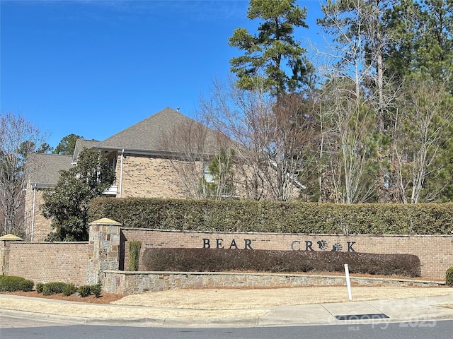 community sign featuring fence