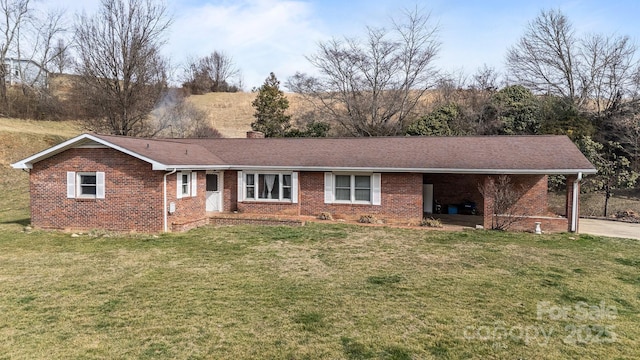 ranch-style home featuring brick siding, a chimney, and a front yard