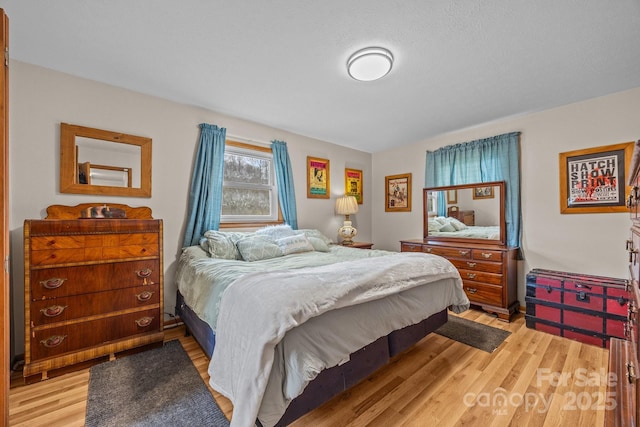 bedroom featuring light wood-style floors