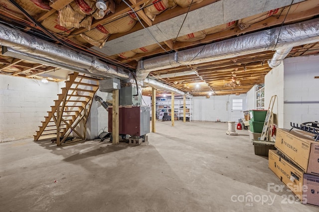 unfinished basement featuring heating unit