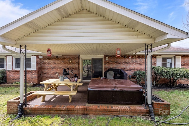 view of patio / terrace featuring grilling area and a covered hot tub