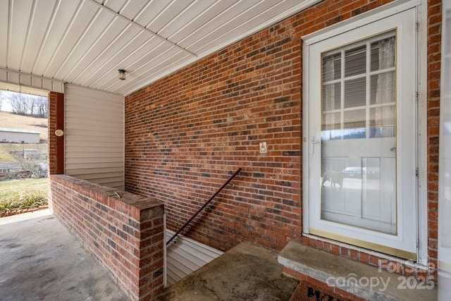 property entrance with brick siding