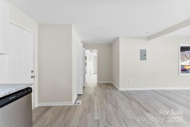 interior space featuring light wood-style flooring, electric panel, visible vents, and baseboards