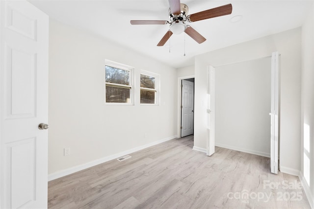 unfurnished bedroom featuring light wood-style floors, ceiling fan, visible vents, and baseboards