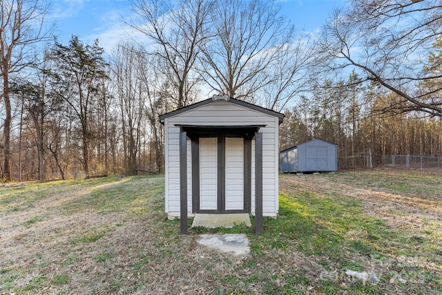 view of shed featuring fence