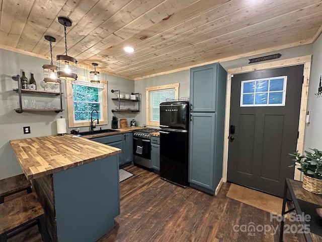 kitchen featuring gas range, wood counters, fridge, open shelves, and a sink