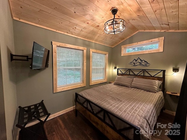 bedroom featuring lofted ceiling, wood ceiling, baseboards, and wood finished floors