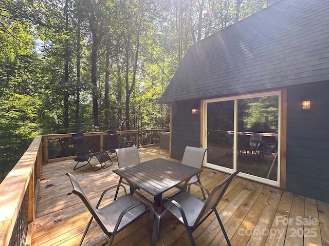 wooden terrace with outdoor dining area