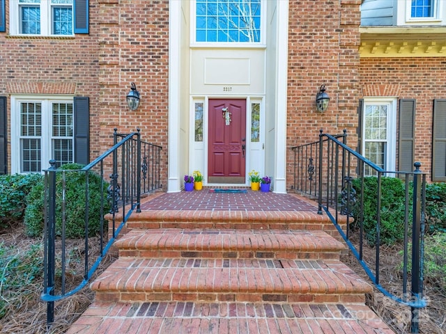 view of exterior entry with brick siding