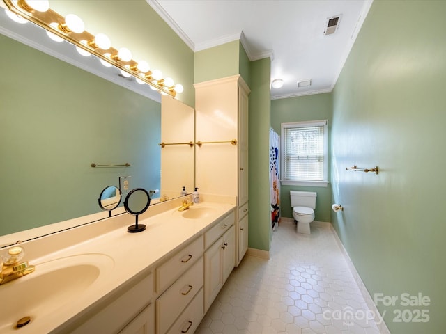 bathroom with toilet, visible vents, ornamental molding, and a sink