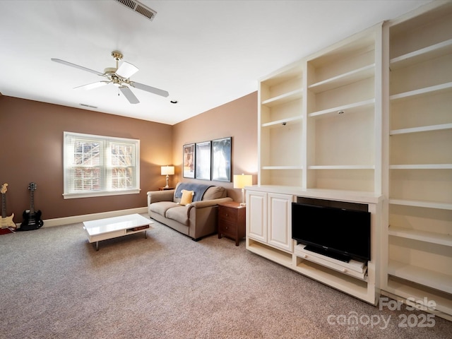 living area with light carpet, ceiling fan, visible vents, and baseboards