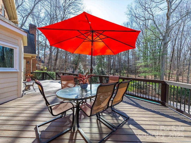 wooden deck featuring outdoor dining space