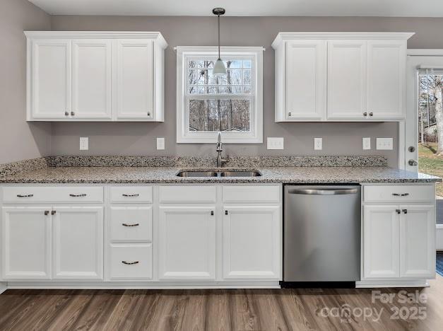 kitchen featuring a sink, light stone counters, white cabinets, and stainless steel dishwasher