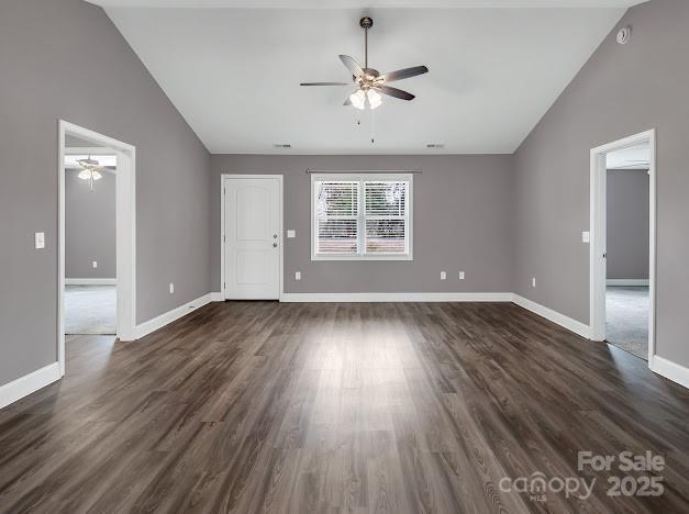 interior space with baseboards, dark wood-style flooring, and a ceiling fan