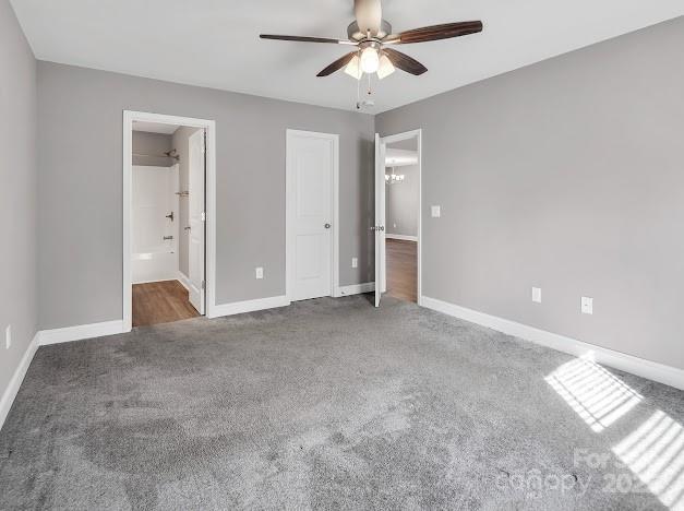 unfurnished bedroom with a ceiling fan, carpet flooring, and baseboards