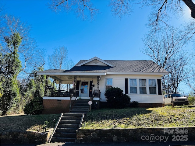 view of front of house featuring a shingled roof, crawl space, covered porch, and stairway