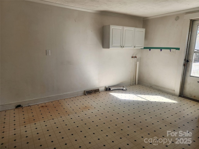 clothes washing area with ornamental molding and visible vents