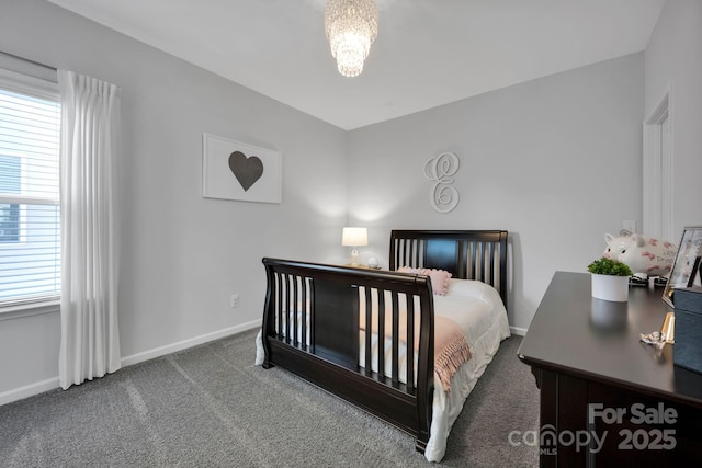 bedroom with baseboards, carpet flooring, a chandelier, and multiple windows
