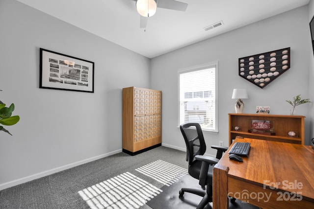 carpeted office with baseboards, a ceiling fan, and visible vents
