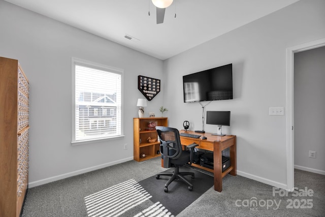 carpeted office space featuring baseboards, a ceiling fan, and visible vents