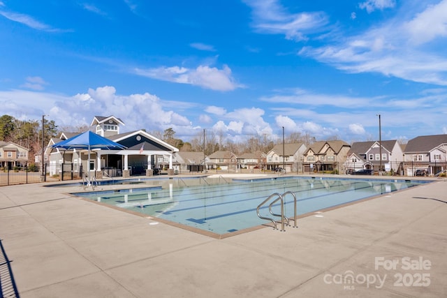 pool featuring fence, a residential view, and a patio