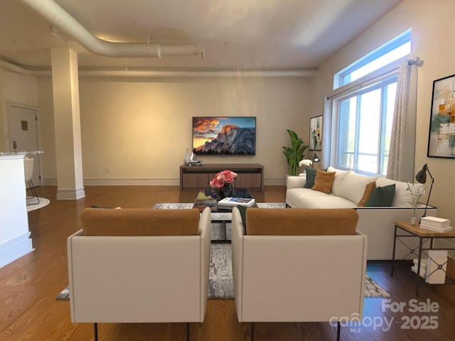 living room featuring baseboards and wood finished floors