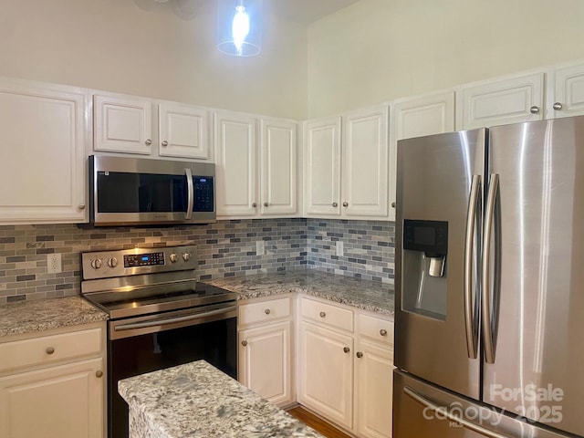 kitchen featuring appliances with stainless steel finishes, backsplash, and white cabinets