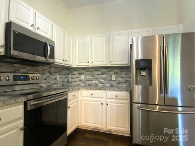 404 N Laurel Ave Unit 28, Charlotte, NC 28204 - kitchen with white cabinetry, stainless steel appliances, tasteful backsplash, and light stone countertops