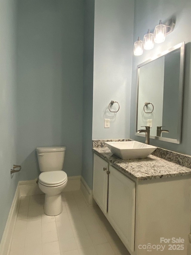 404 N Laurel Ave Unit 28, Charlotte, NC 28204 - bathroom featuring toilet, baseboards, and vanity