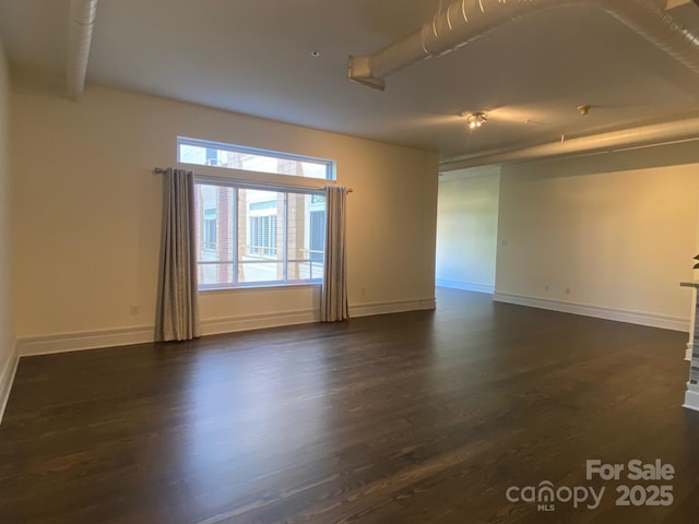 404 N Laurel Ave Unit 28, Charlotte, NC 28204 - spare room with baseboards and dark wood-style floors