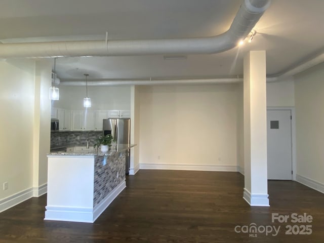 404 N Laurel Ave Unit 28, Charlotte, NC 28204 - interior space with dark wood-type flooring, baseboards, stainless steel refrigerator with ice dispenser, and a sink