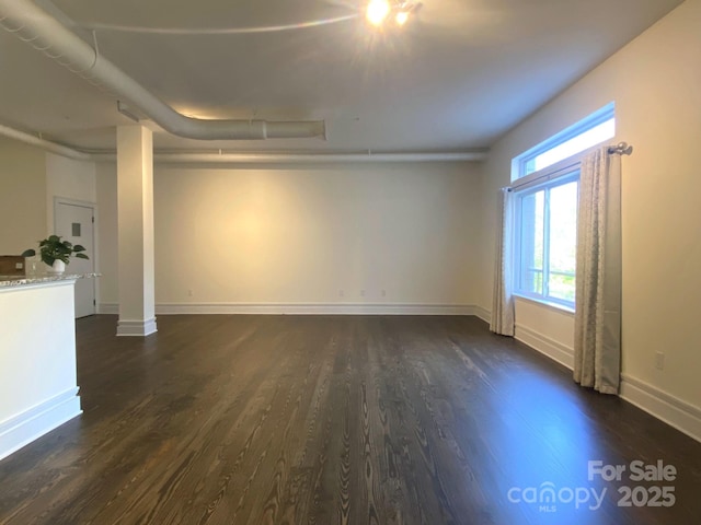 404 N Laurel Ave Unit 28, Charlotte, NC 28204 - unfurnished living room featuring baseboards and dark wood-style floors