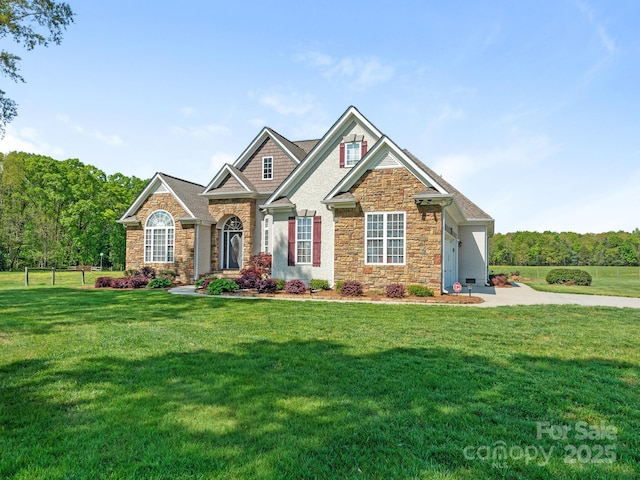 craftsman inspired home with stone siding and a front lawn