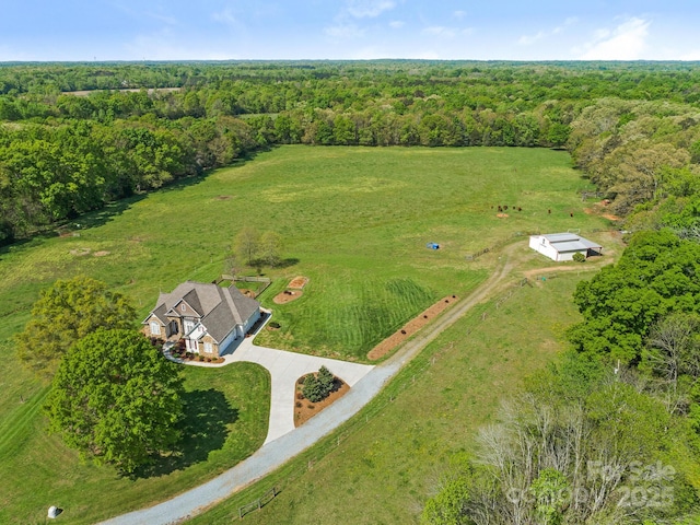 drone / aerial view featuring a rural view and a forest view
