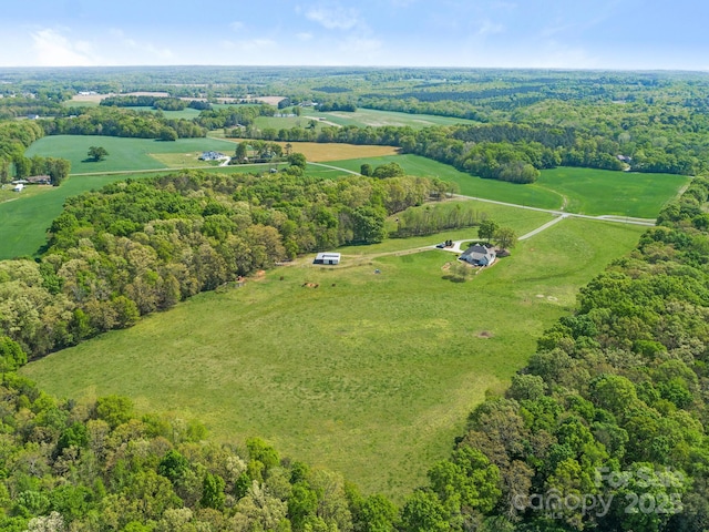 birds eye view of property featuring a rural view and a forest view