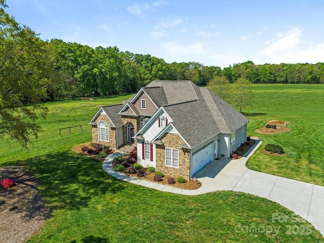 birds eye view of property featuring a wooded view