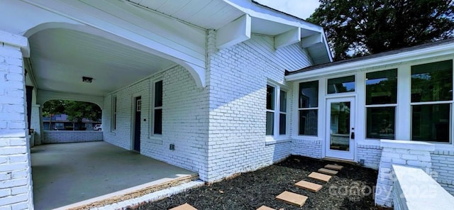 view of side of property featuring brick siding
