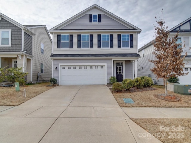 view of front of home with concrete driveway and an attached garage