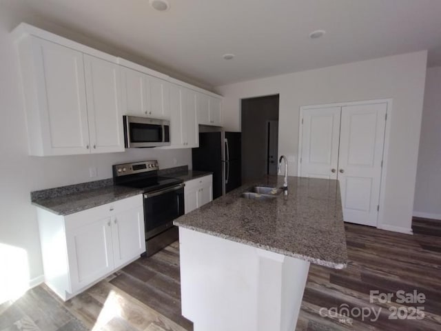 kitchen featuring appliances with stainless steel finishes, white cabinets, and a sink