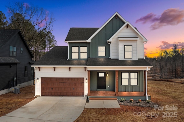 view of front of home featuring board and batten siding, covered porch, driveway, and an attached garage