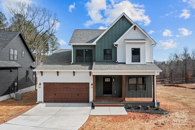 modern farmhouse style home featuring a shingled roof, a porch, board and batten siding, a garage, and driveway