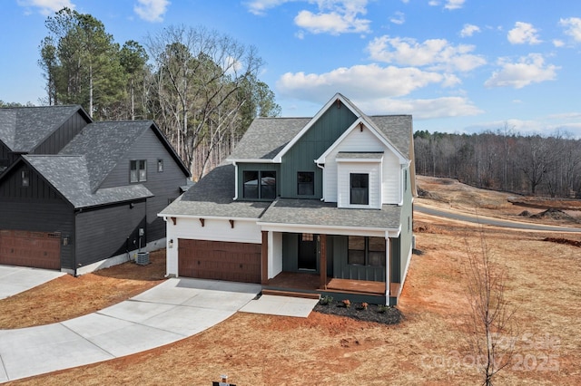 modern farmhouse style home with driveway, roof with shingles, covered porch, cooling unit, and board and batten siding