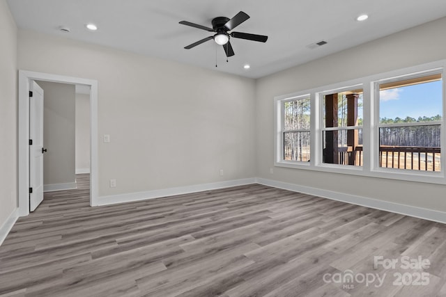 empty room with recessed lighting, wood finished floors, and a healthy amount of sunlight