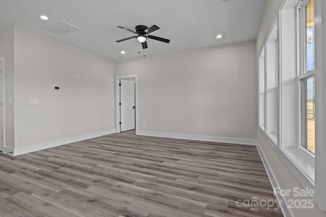 unfurnished room with a ceiling fan, baseboards, wood finished floors, and recessed lighting